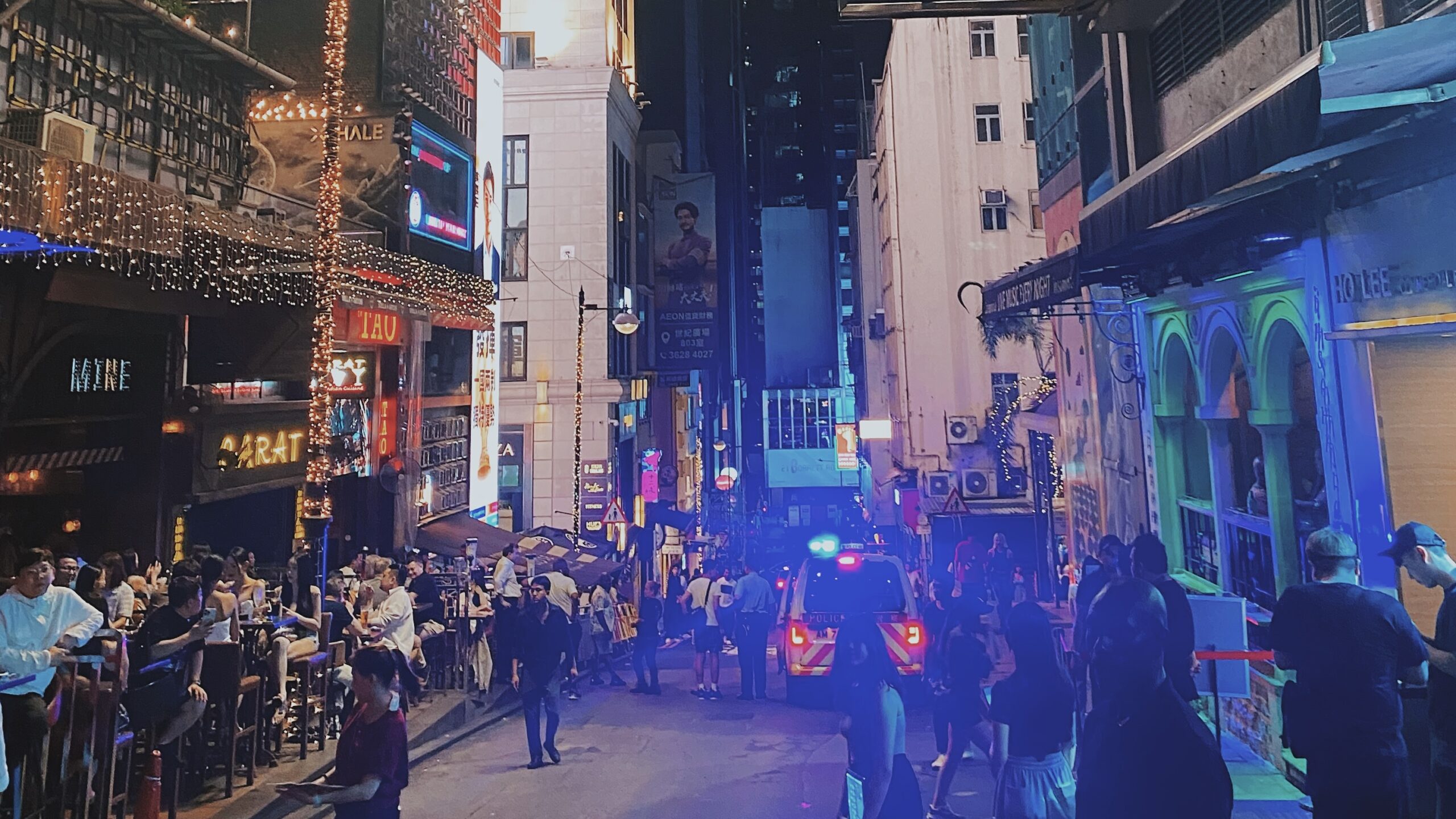 Where to Stay in Hong Kong for Solo Travelers (Best Areas to Meet People) Lan Kwai Fong nightlife crowd in Hong Kong with people socializing on a busy street at night