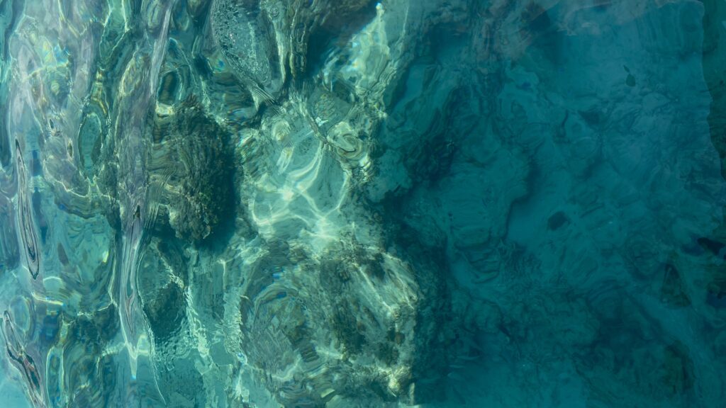 Crystal clear turquoise water over coral reef in Gili Trawangan, showcasing vibrant marine life and tropical island scenery