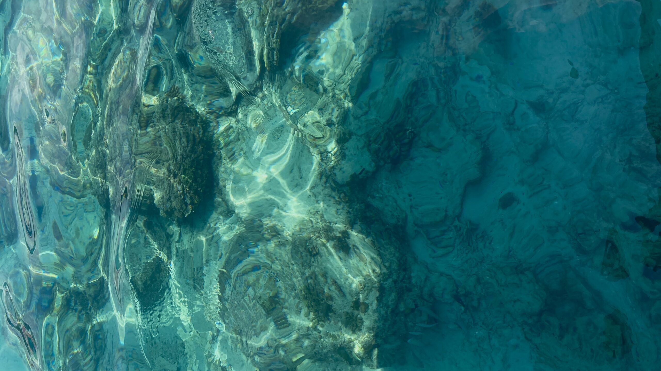 Crystal clear turquoise water over coral reef in Gili Trawangan, showcasing vibrant marine life and tropical island scenery
